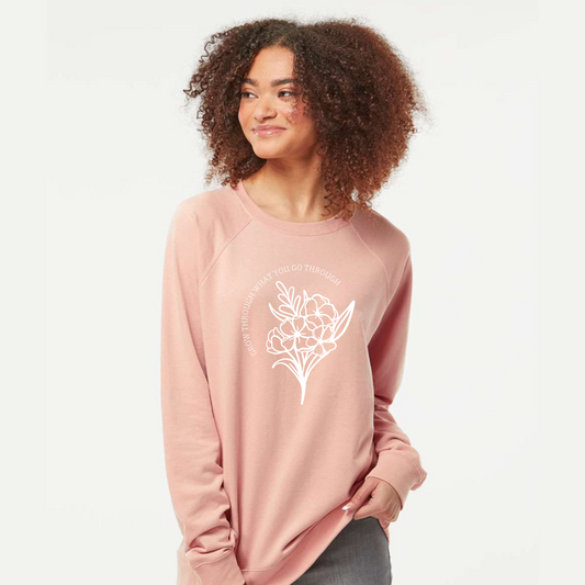 Woman wearing a pink long-sleeve shirt with a white floral design on a light gray background