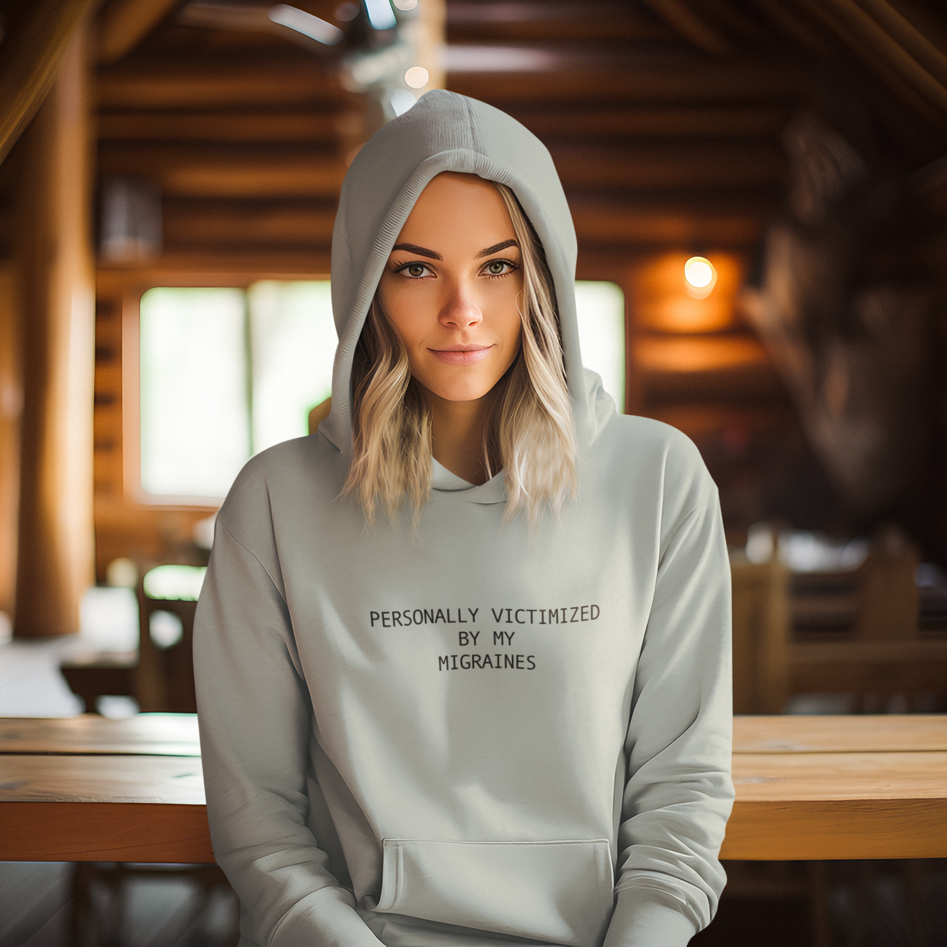 Person wearing a light green hoodie with text in a wooden interior setting