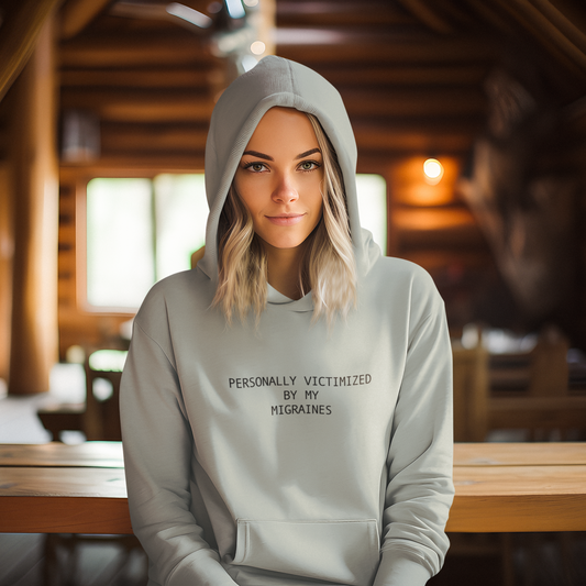 Person wearing a light green hoodie with text in a wooden interior setting