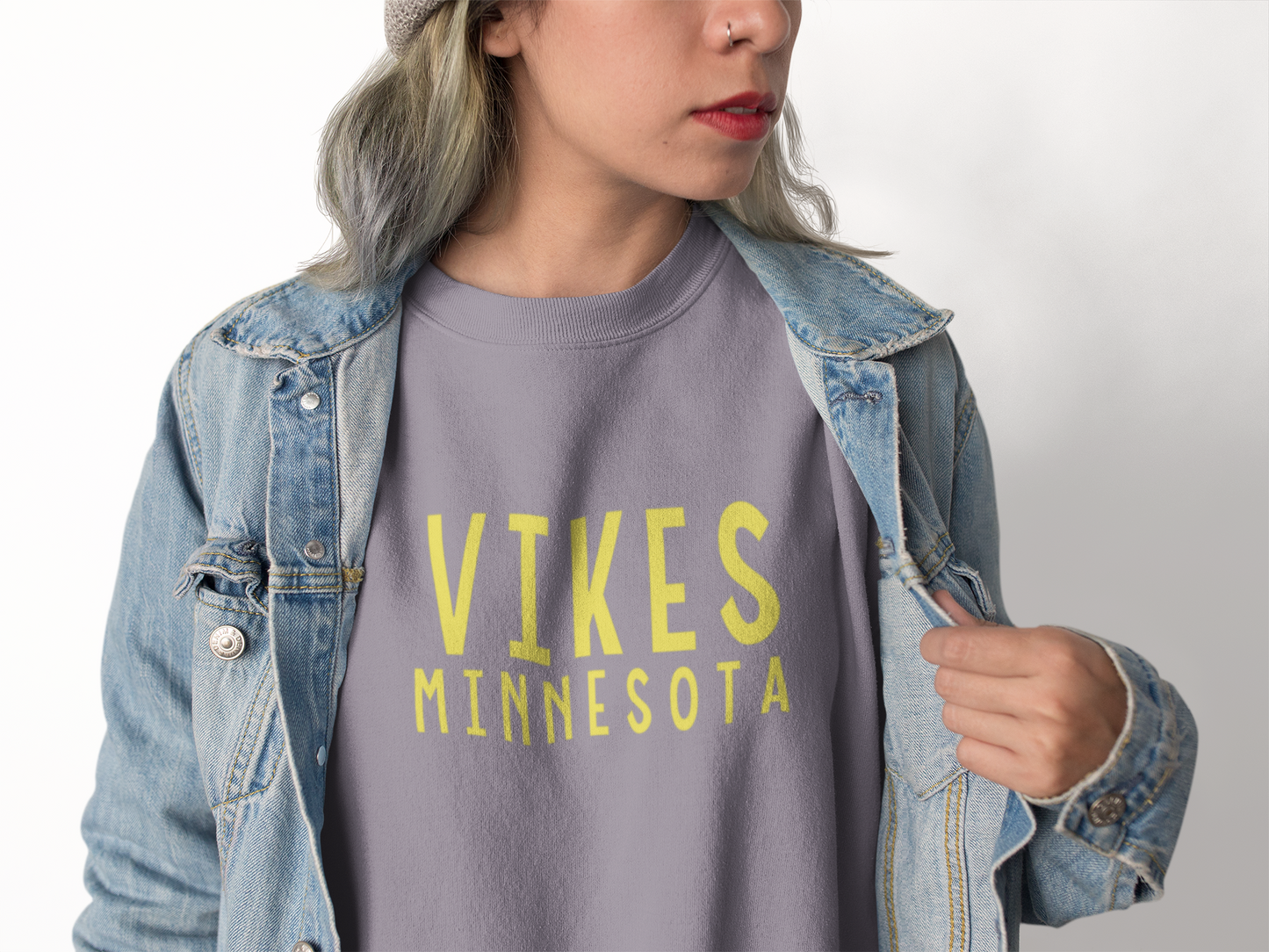 Minnesota Vikings Crewneck Sweatshirt on a model with a jean jacket over the top on a model
