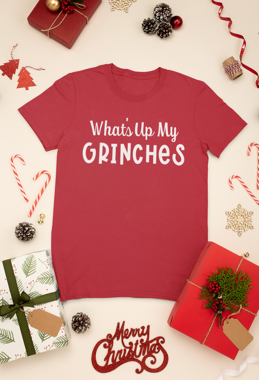 What's Up My Grinches? - T-Shirt laid out In a stylized setting