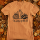 Hello Fall Pumpkin T-Shirt - front view on a background of leaves