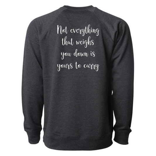 Not Everything That Weighs You Down - Pull Over Sweatshirt in charcoal gray. The back has a white cursive saying of "not everything that weighs you down is yours to carry" with the front corner pocket saying in a cursive font in white of "keep smiling". This is the back view of the sweatshirt.