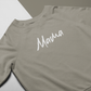 Green Mama - Pull Over Sweatshirt - front viewMama - Pull Over Sweatshirt in olive green with a white cursive modern font design with "mama" on it. This is the front view of the sweatshirt laid flat on a white and olive green background.