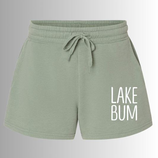 Lake Bum Shorts in a light mint green color with a "lake bum" saying on the right hand corner of the shorts. This is the front view of the shorts on a gray to white gradient background.