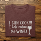 I Can Cook T-Shirt in maroon folded on a brown wooden background