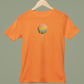 Orange t-shirt with a colorful graphic on a hanger against a green background