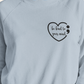 Dear Person Behind Me - Pull Over Sweatshirt in light blue. Designs are in black. The back says "Dear person behind me, the world is a better place with you in it. Love the person in front of you" in a cursive design. The front design is on the right hand side, as a small pocket square with the saying "be kind to your mind" in cursive with a heart and semi colon surrounding it. This is the front view of the sweatshirt on a model (up close view)