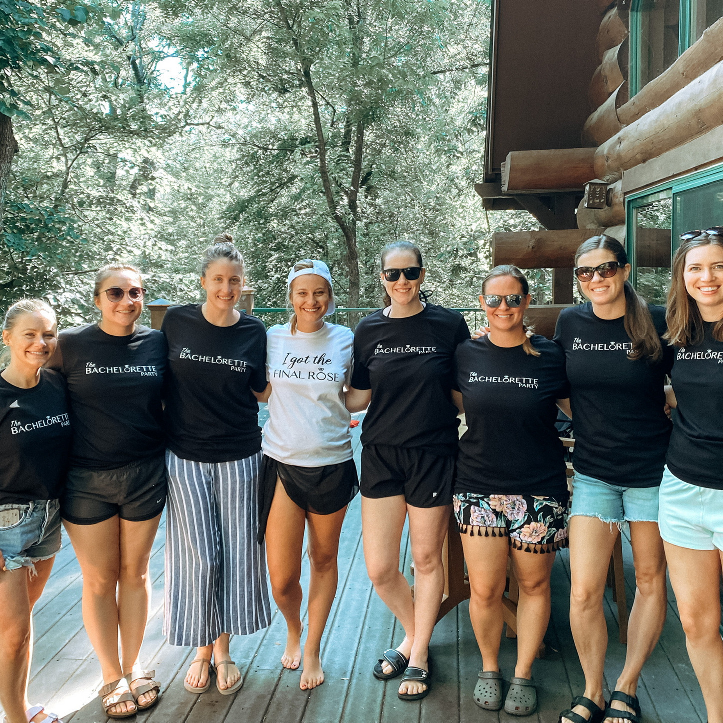 I Got The Final Rose Bride T-Shirt in white. The front has the saying "I got the final rose" with the O in rose being a diamond ring. The "I got the" is in a script font with the "final rose" is in a bold font. Design is in black. This is the an image of the bride with her bridal party.