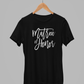 Matron of Honor T-Shirt in black with white script font writing on the front. This is the front view of the shirt hanging on a wooden hanger, hanging on a metal clothing rack.