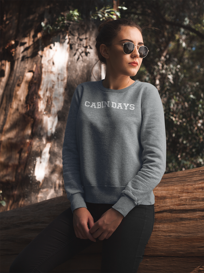 Cabin Days Sweatshirt on a model in a woodsy area.